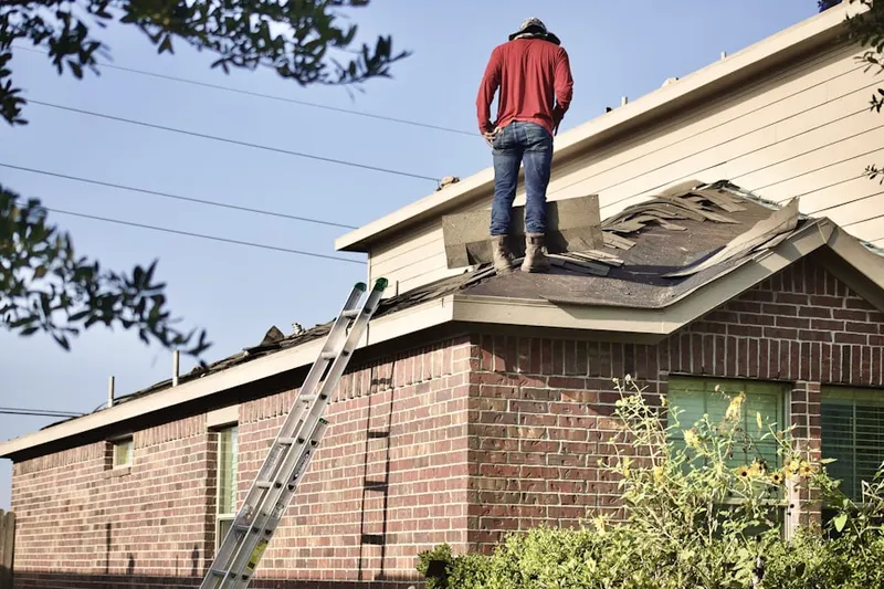 Professional roofer working on a residential roof in Hauppauge